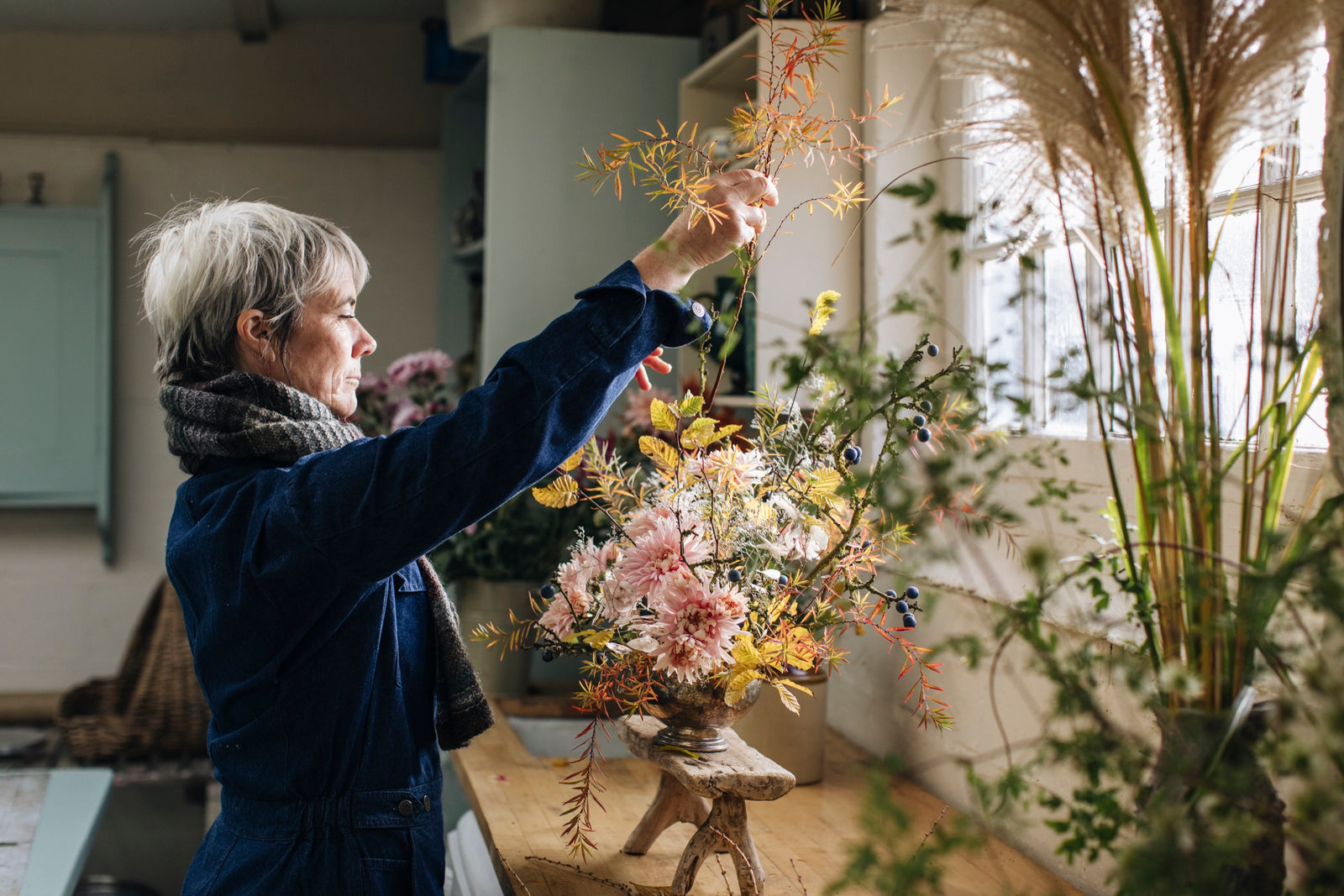 Rachel Siegfried arranging perennials and grasses in her workshop